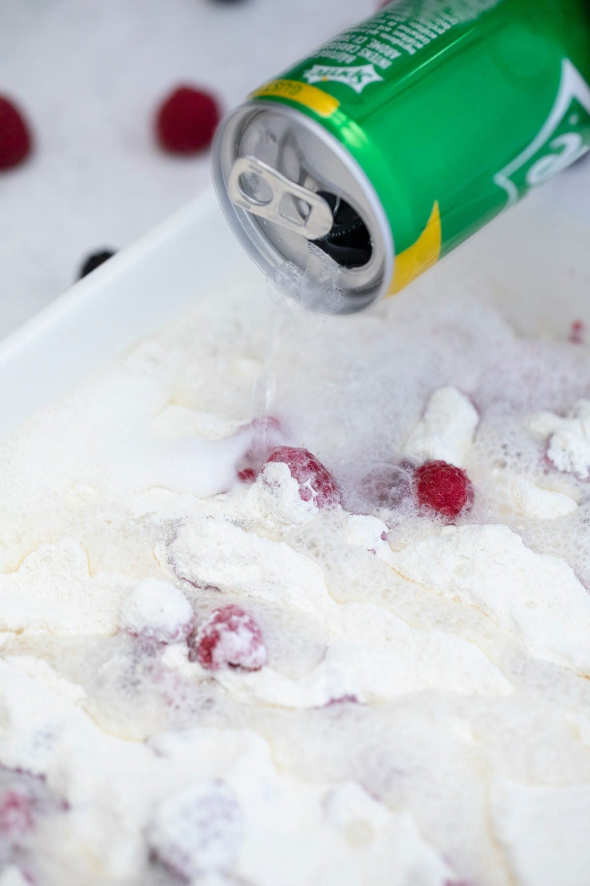 Pouring sprite over berries