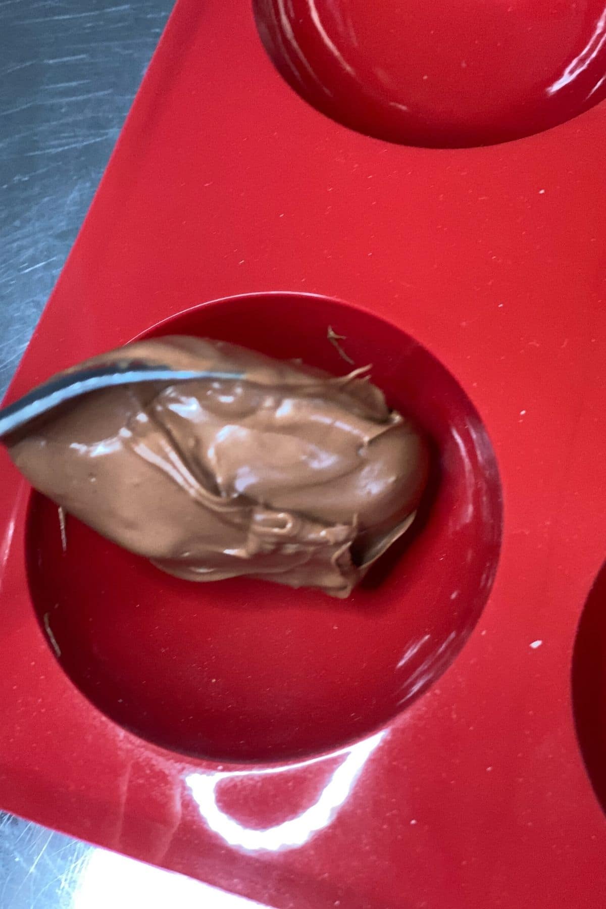 Spooning chocolate into a silicone mold