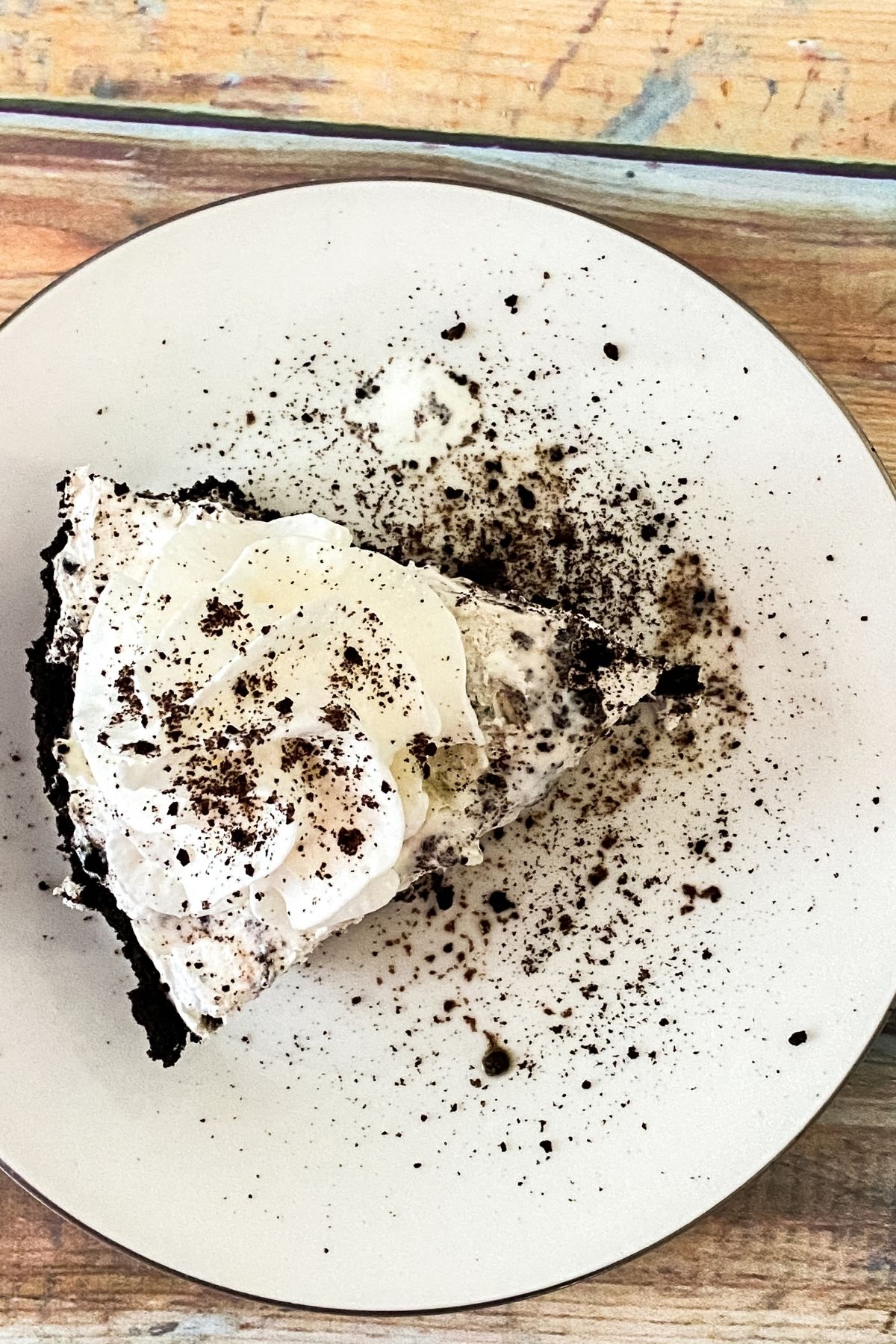 Slice of Oreo cheesecake on white plate