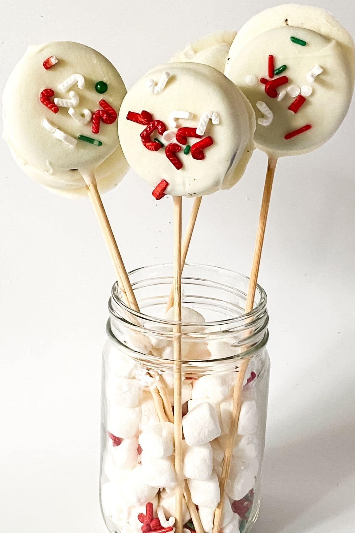 Dipped Oreo pops standing in glass