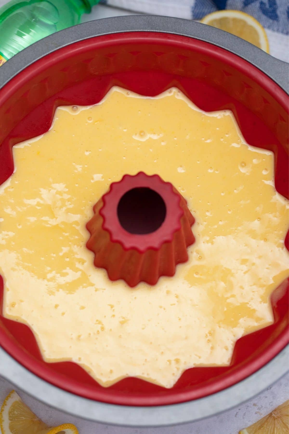 Unbaked cake batter in red budnt pan