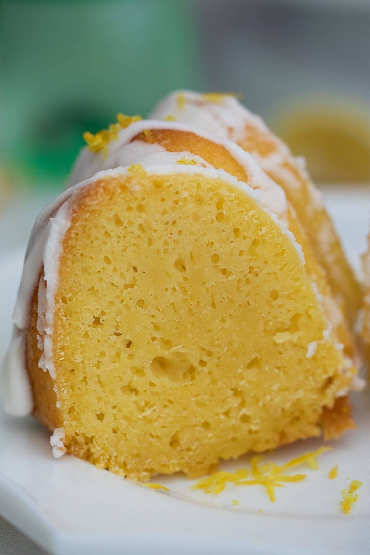 Slices of cake on plate showing moist yellow cake 
