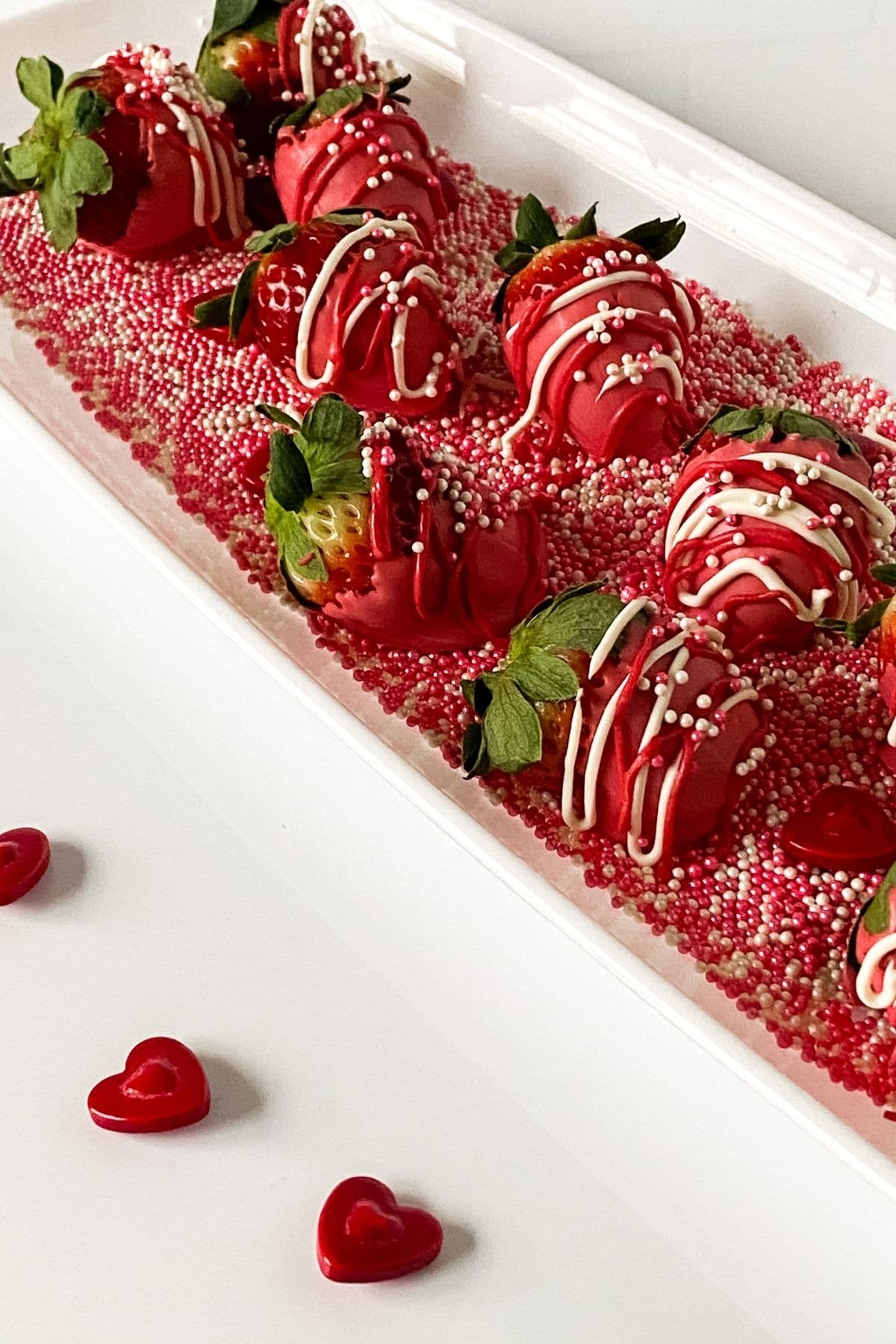 Pink chocolate covered strawberries on tray