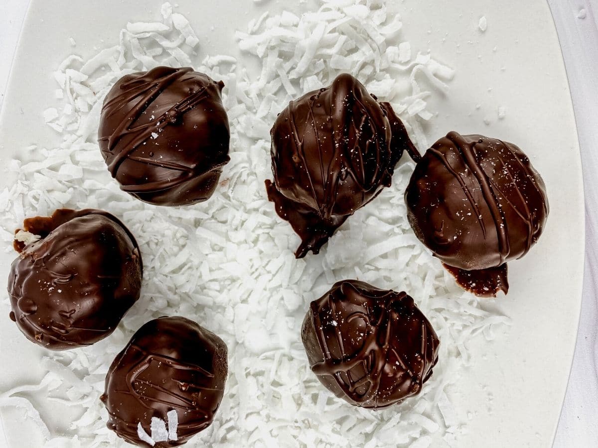Chocolate coconut truffles on white plate