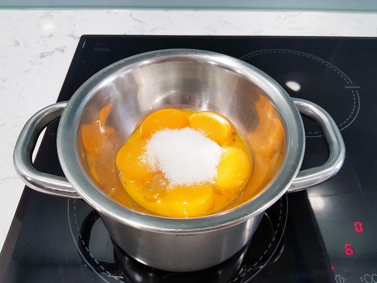 Eggs and sugar in pan