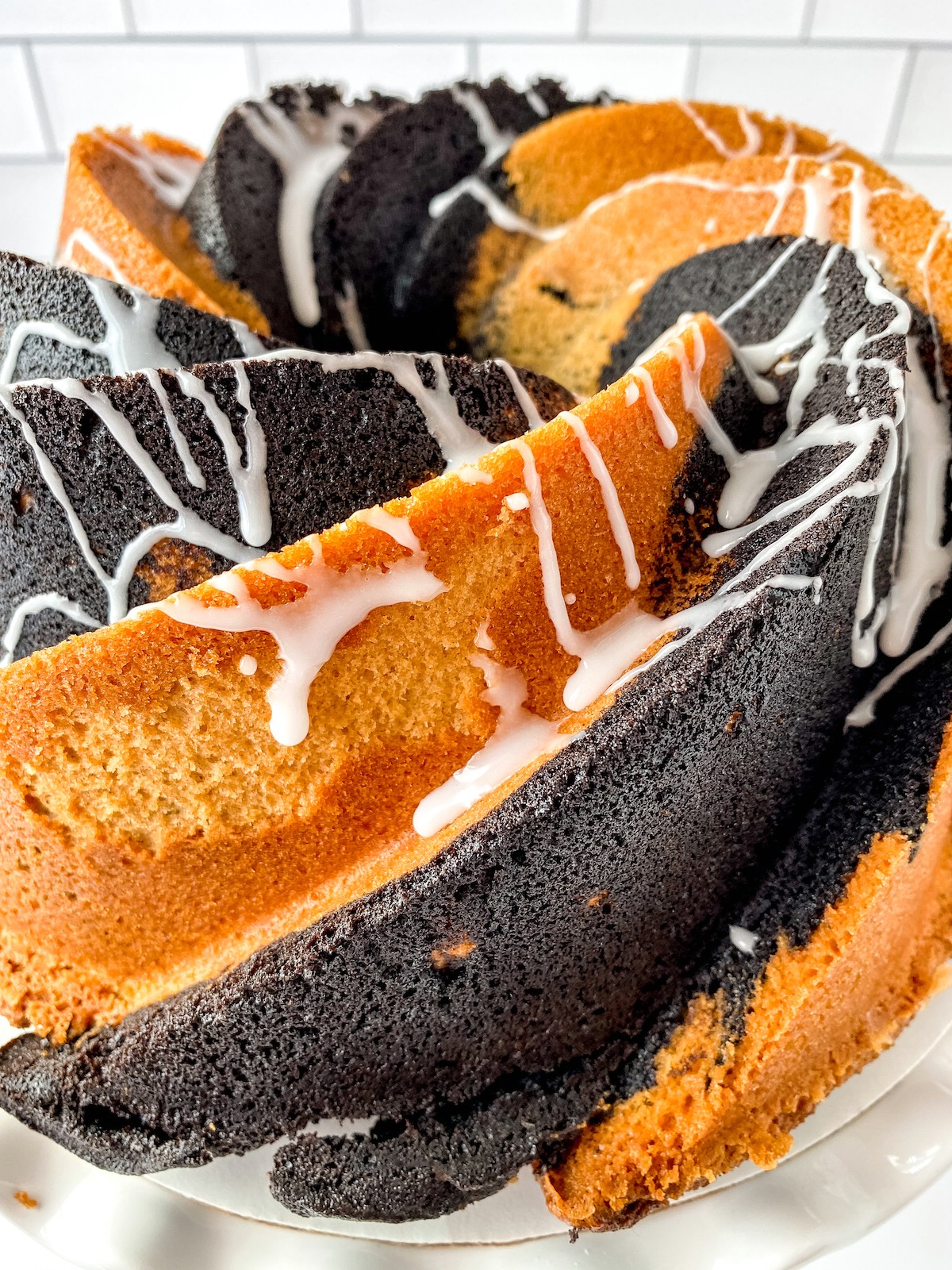 Glazed vanilla chocolate swirl bundt cake on stand