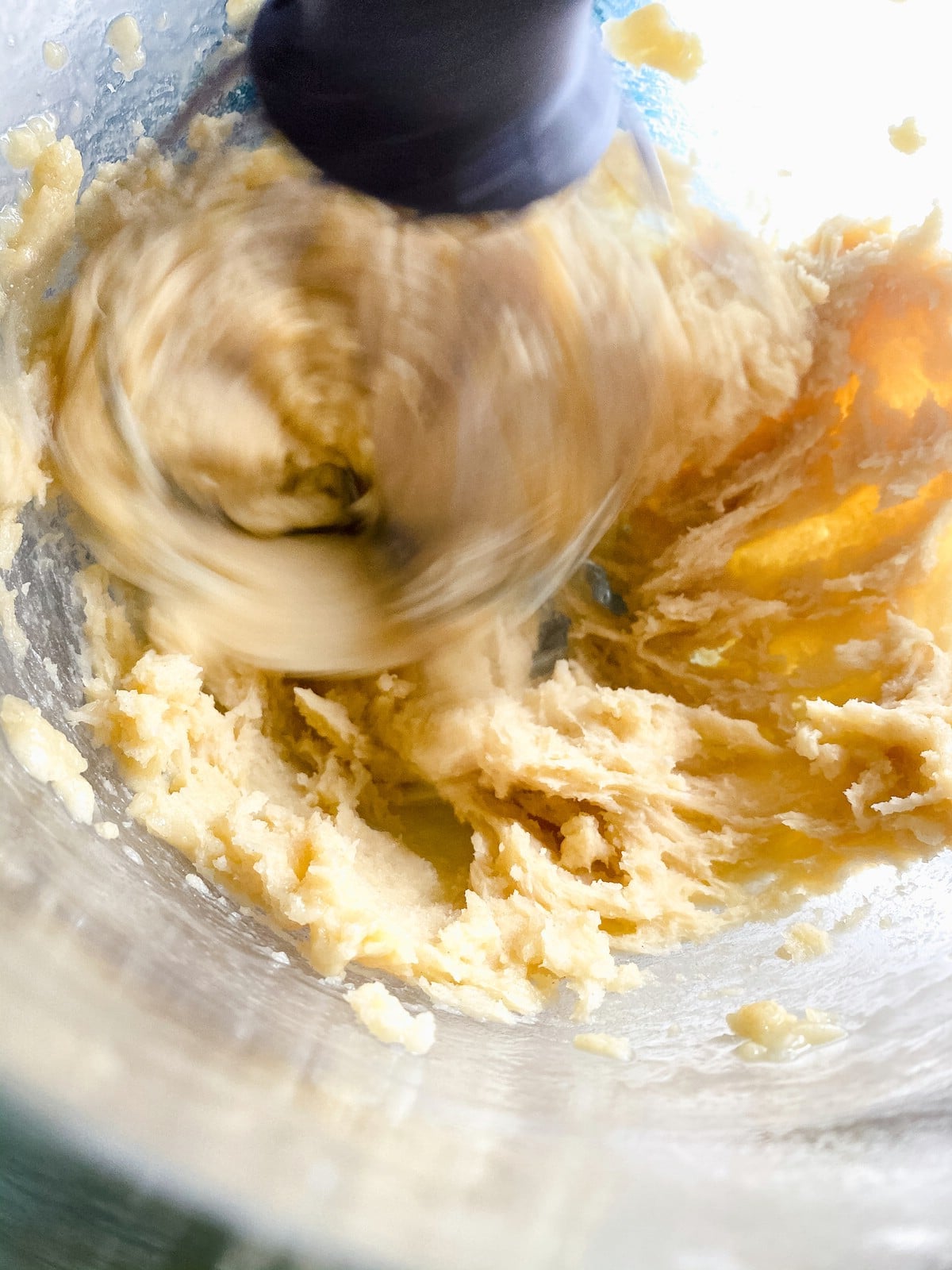 Churro dough being mixed in bowl