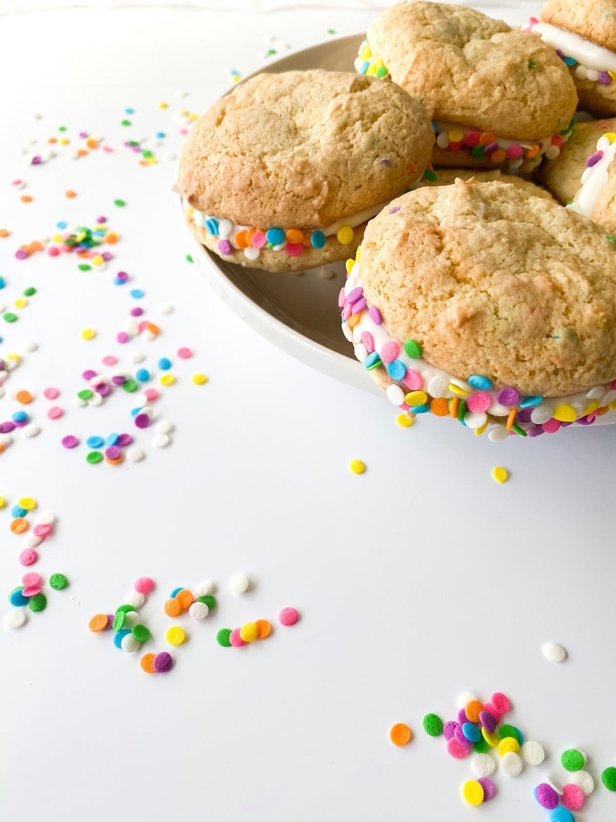 Confetti sandwich cookies stacked on platter