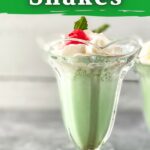 Single glass filled with green milkshake on table
