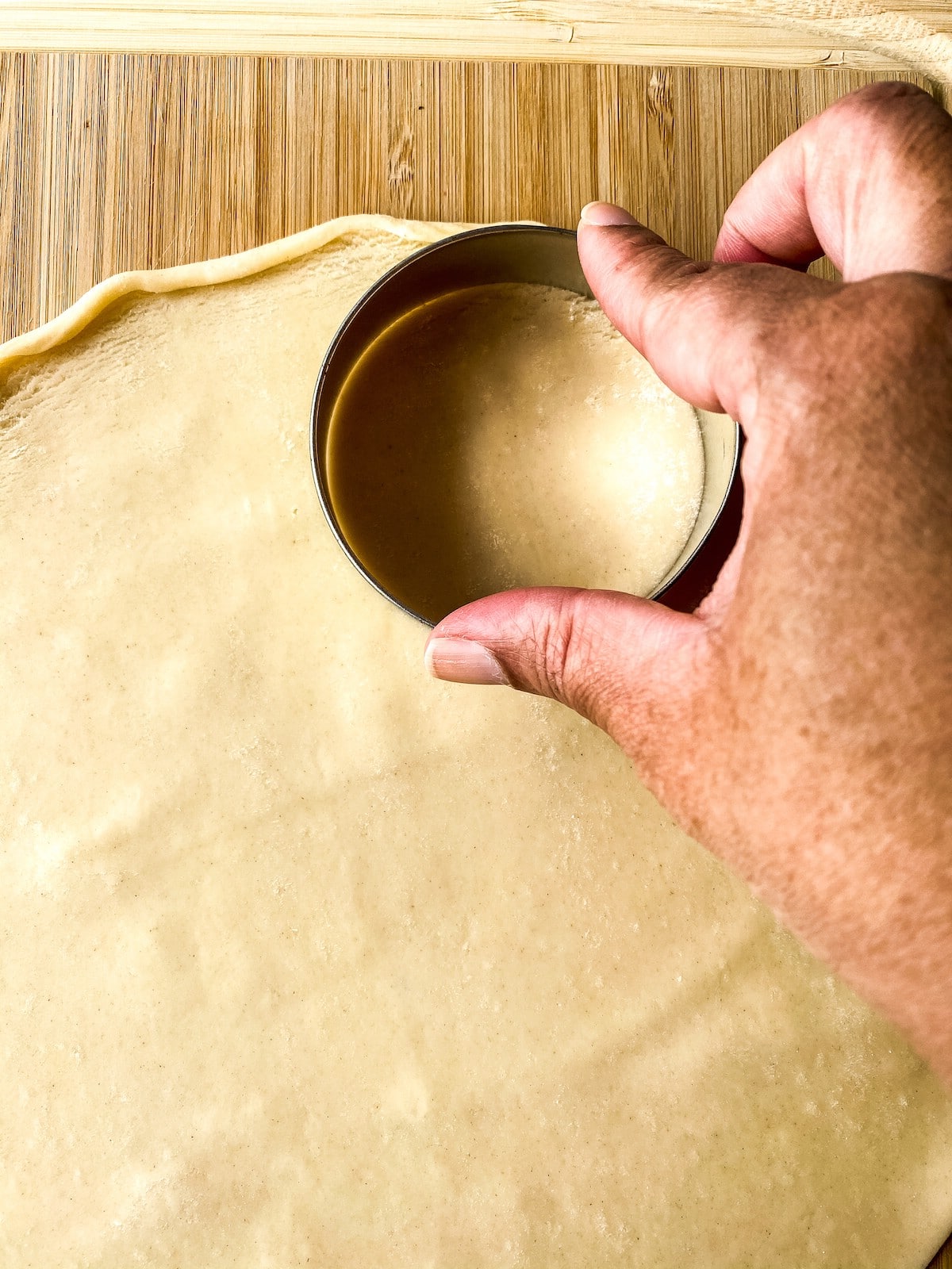 Cutting circles out of dough with cookie cutter
