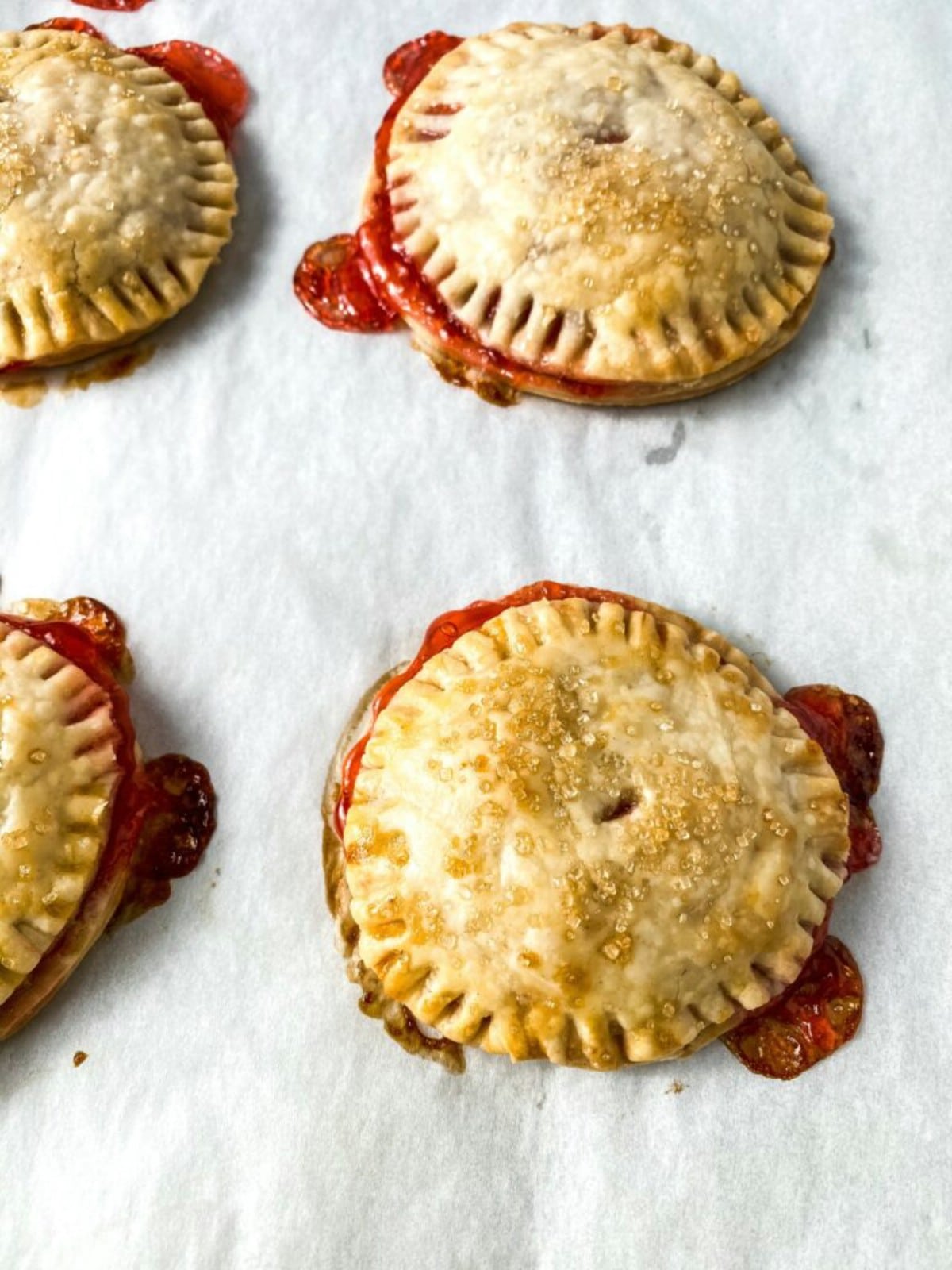 Strawberry hand pies on parchment paper