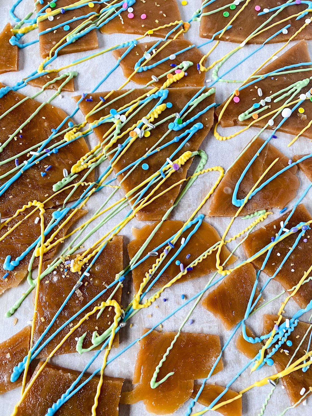 Toffee with chocolate and sprinkles on parchment paper