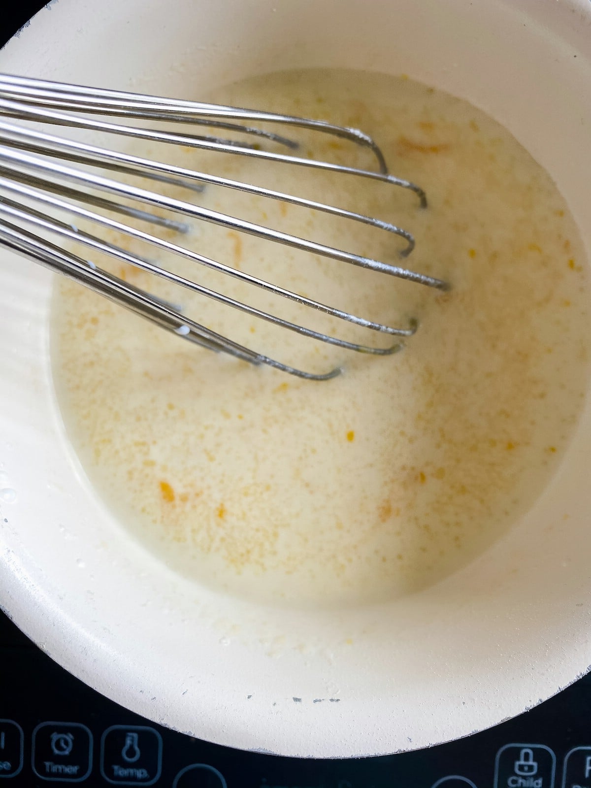 Whisking eggs into pudding