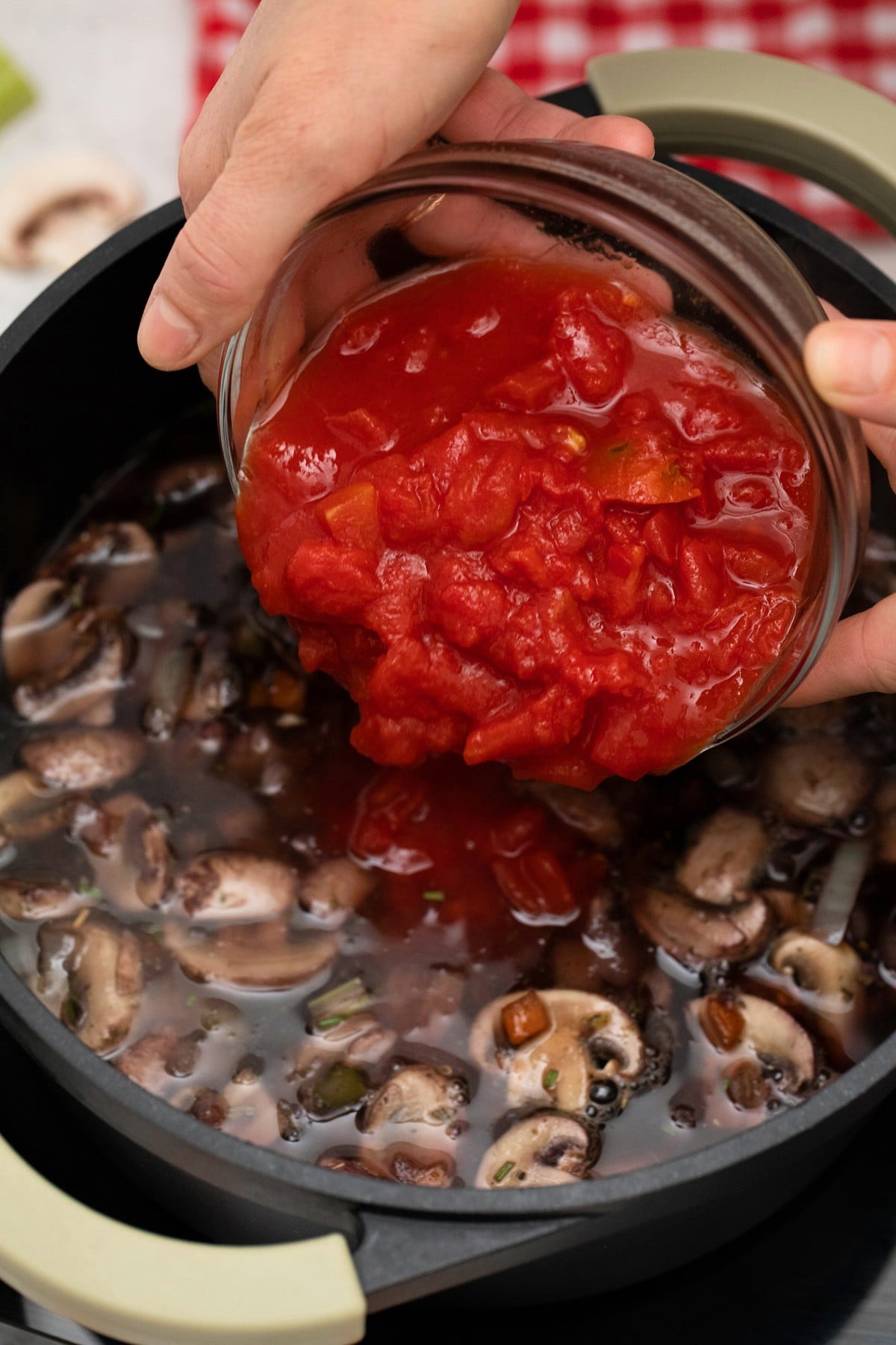 Pouring tomatoes into soup pan