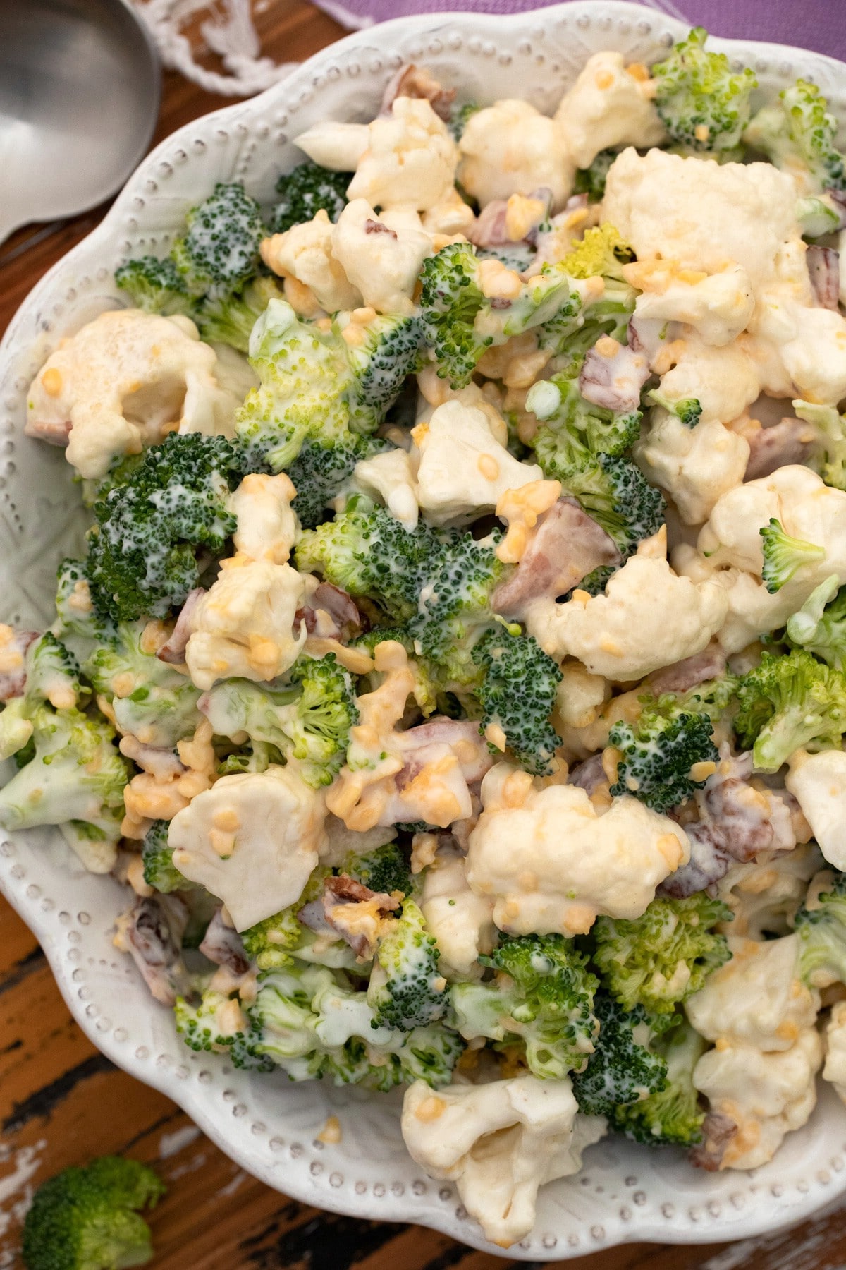 Broccoli salad with bacon in white bowl