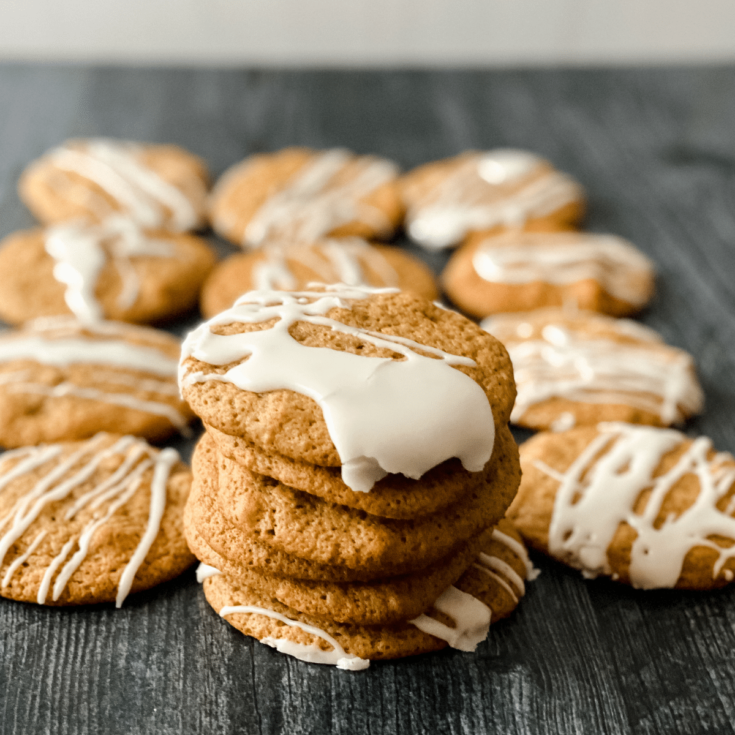Brown butter cookies with icing on black surface