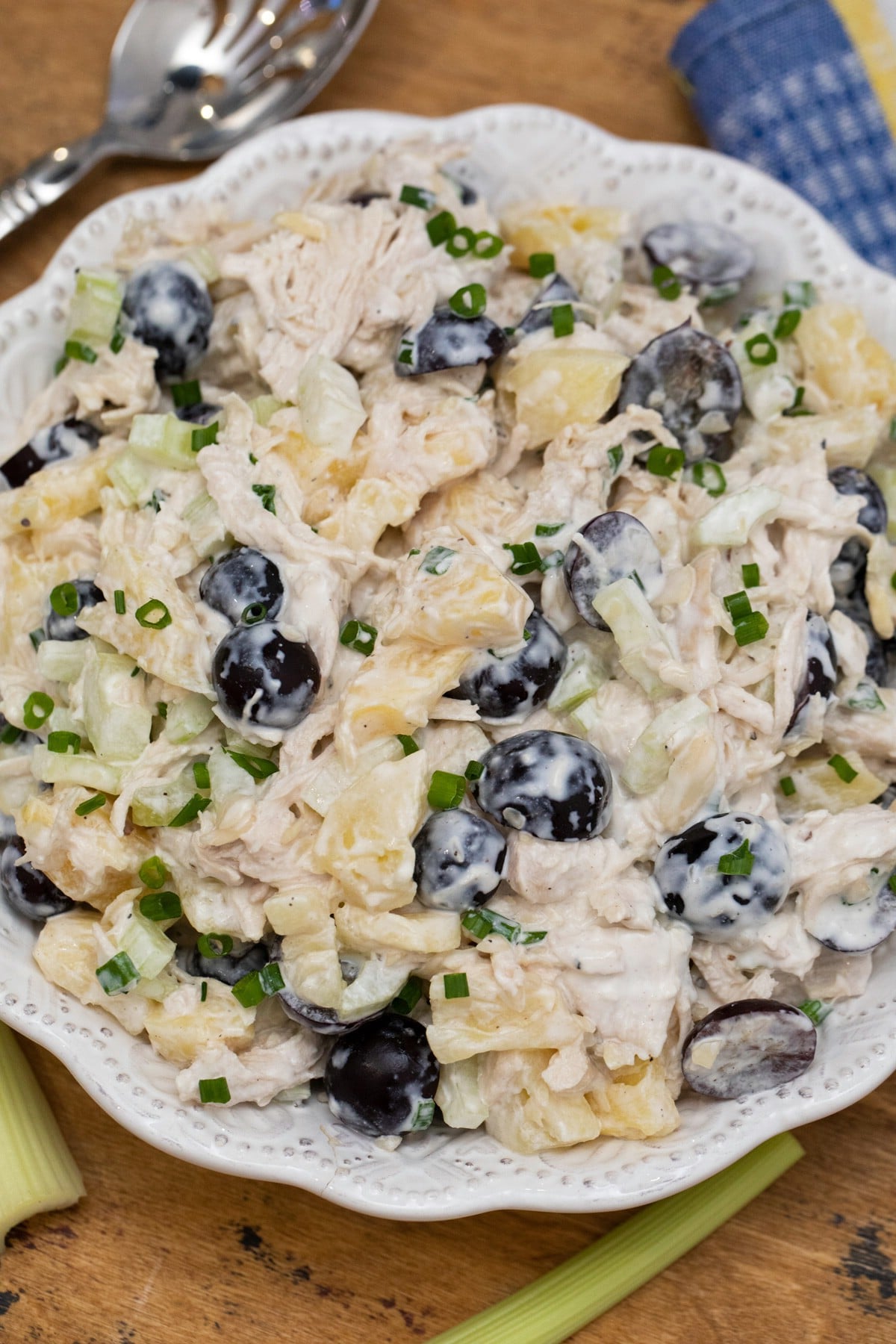 White bowl with chicken sald topped with grapes