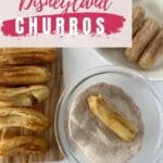 Cooked churros being rolled in cinnamon sugar