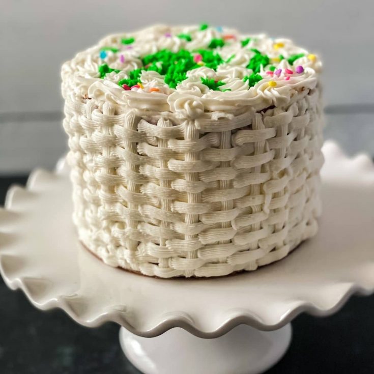 White basket weave cake on white cake stand