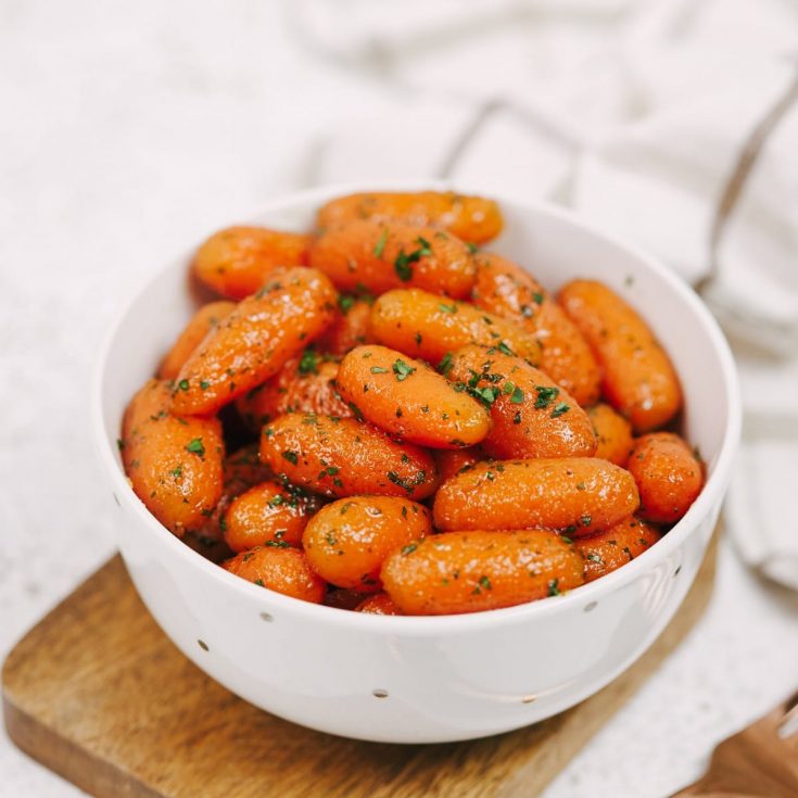 White bowl filled with candied carrots