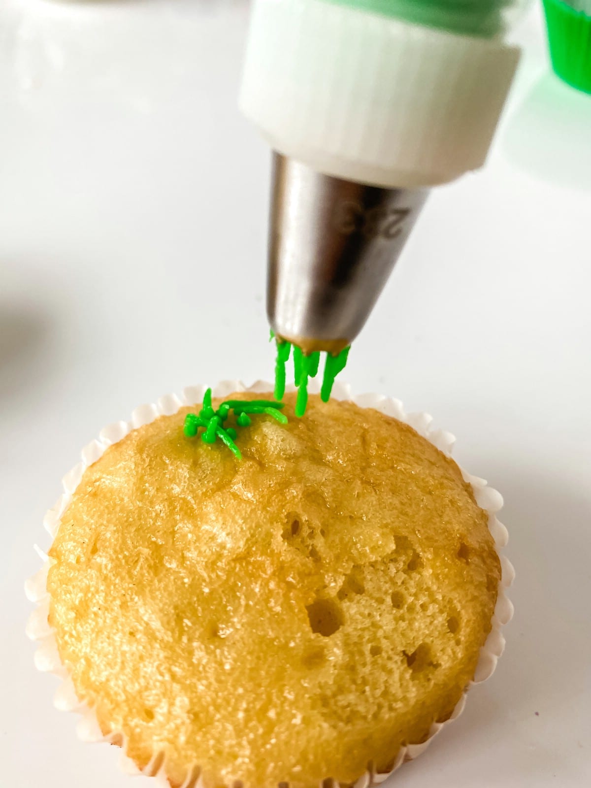 Adding grass using icing to top of cupcake