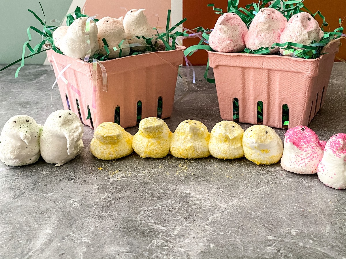 Yellow homemade peeps lined up in front of pink baskets