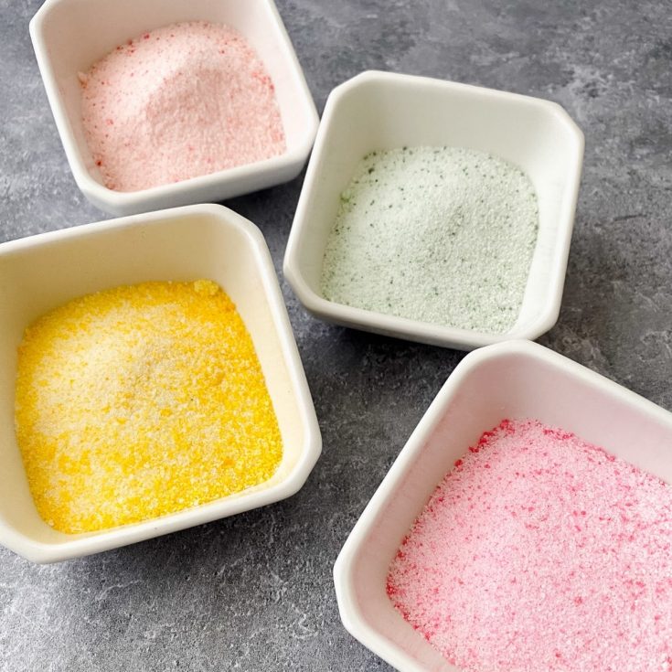 Pastel sanding sugar in white bowls
