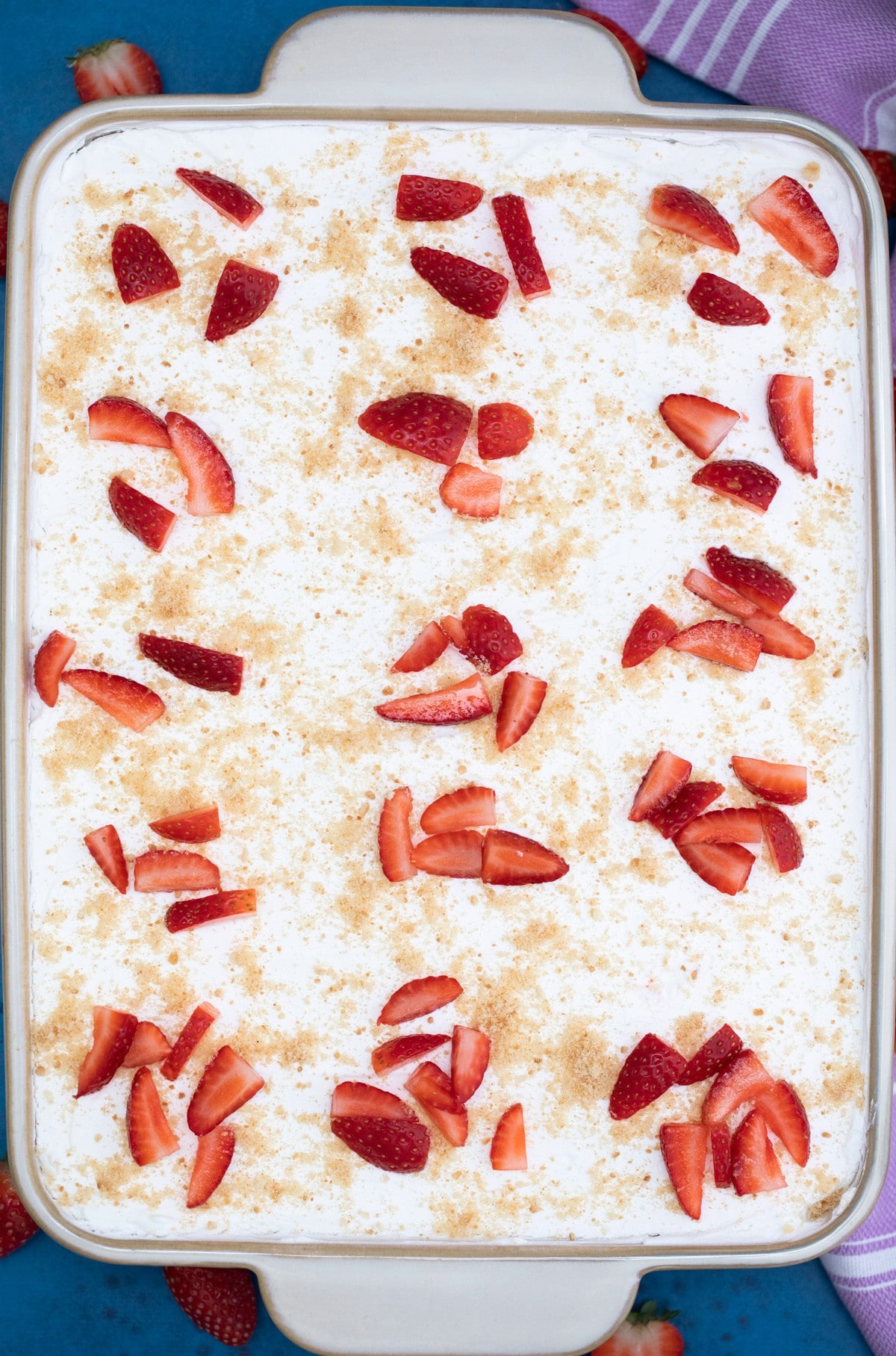 Overhead of dessert in baking dish with strawberries on top