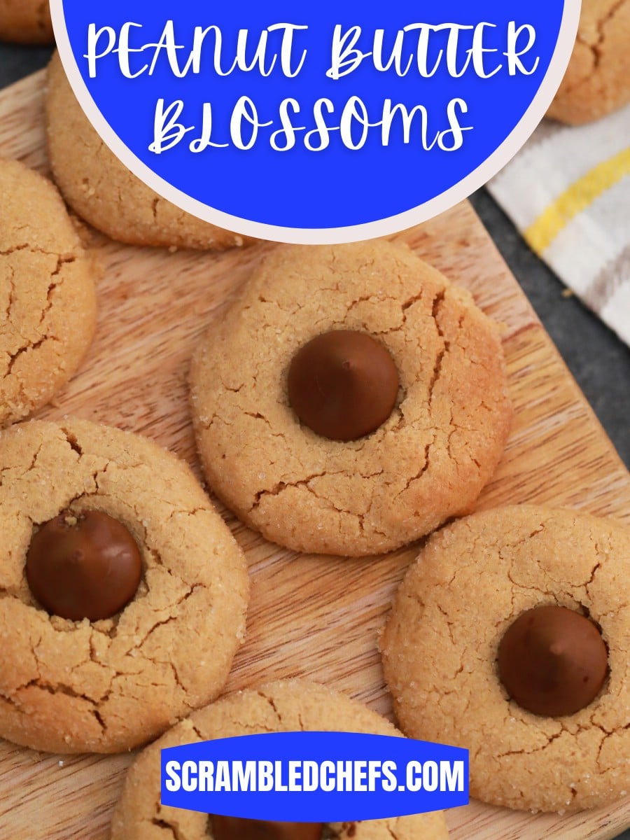 Cookies on cutting board with blue banner over top saying peanut butter blossoms