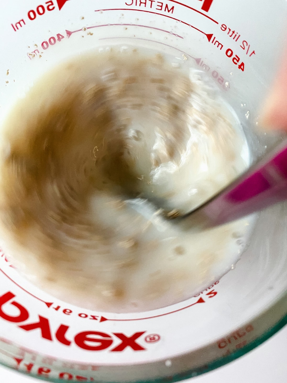 Mixing yeast in measuring cup