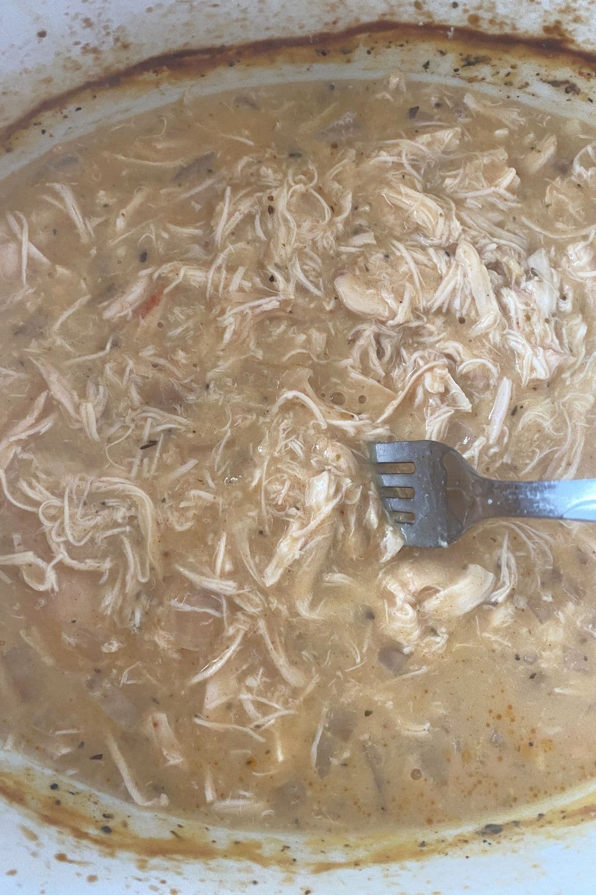 Shredded chicken in soup mixture in slow cooker