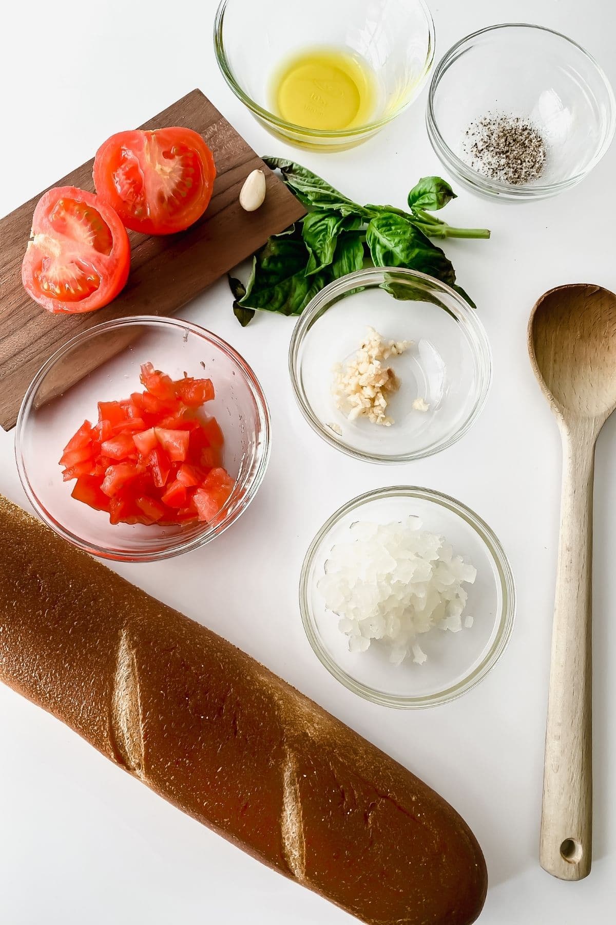 Ingredients for homemade bruschetta on white table