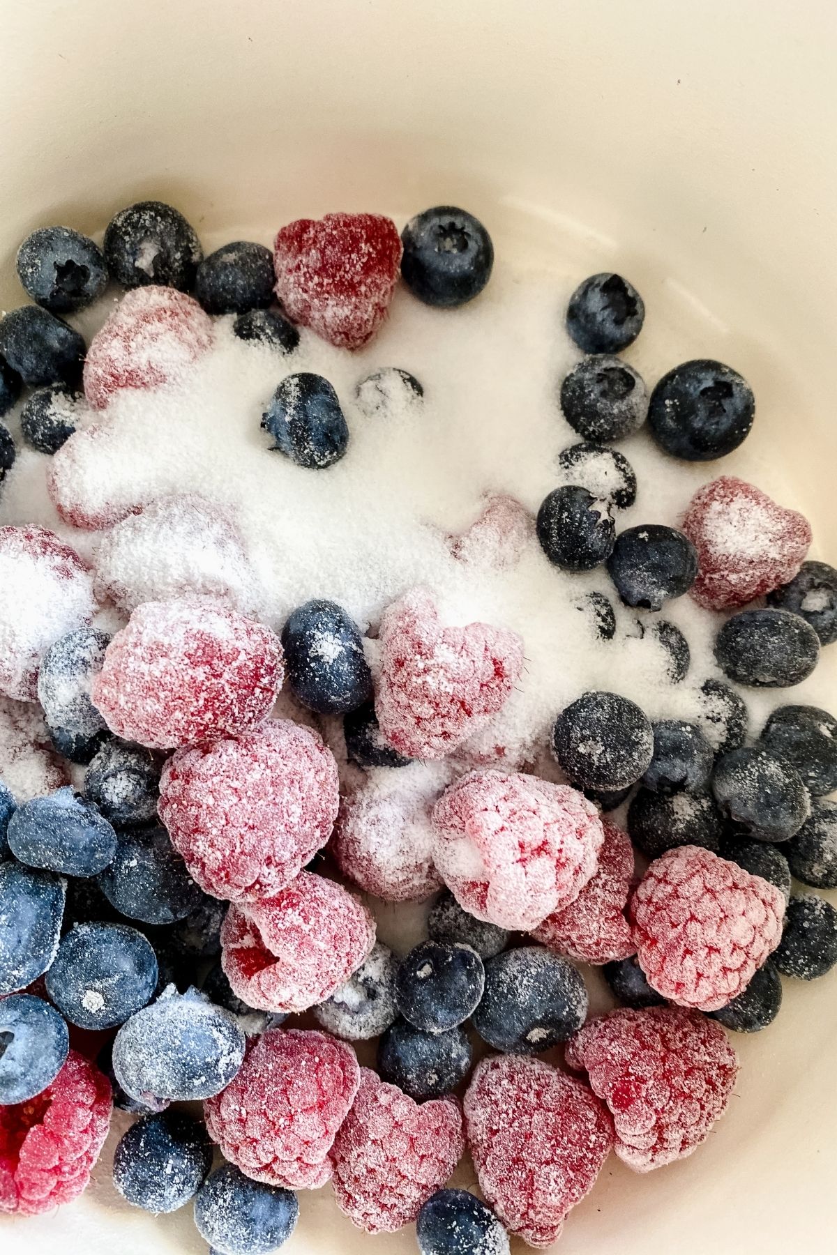Berries and sugar in pan