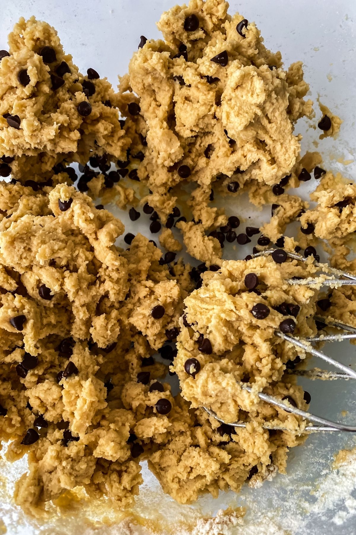 Cookie dough with chocolate chips and whisk