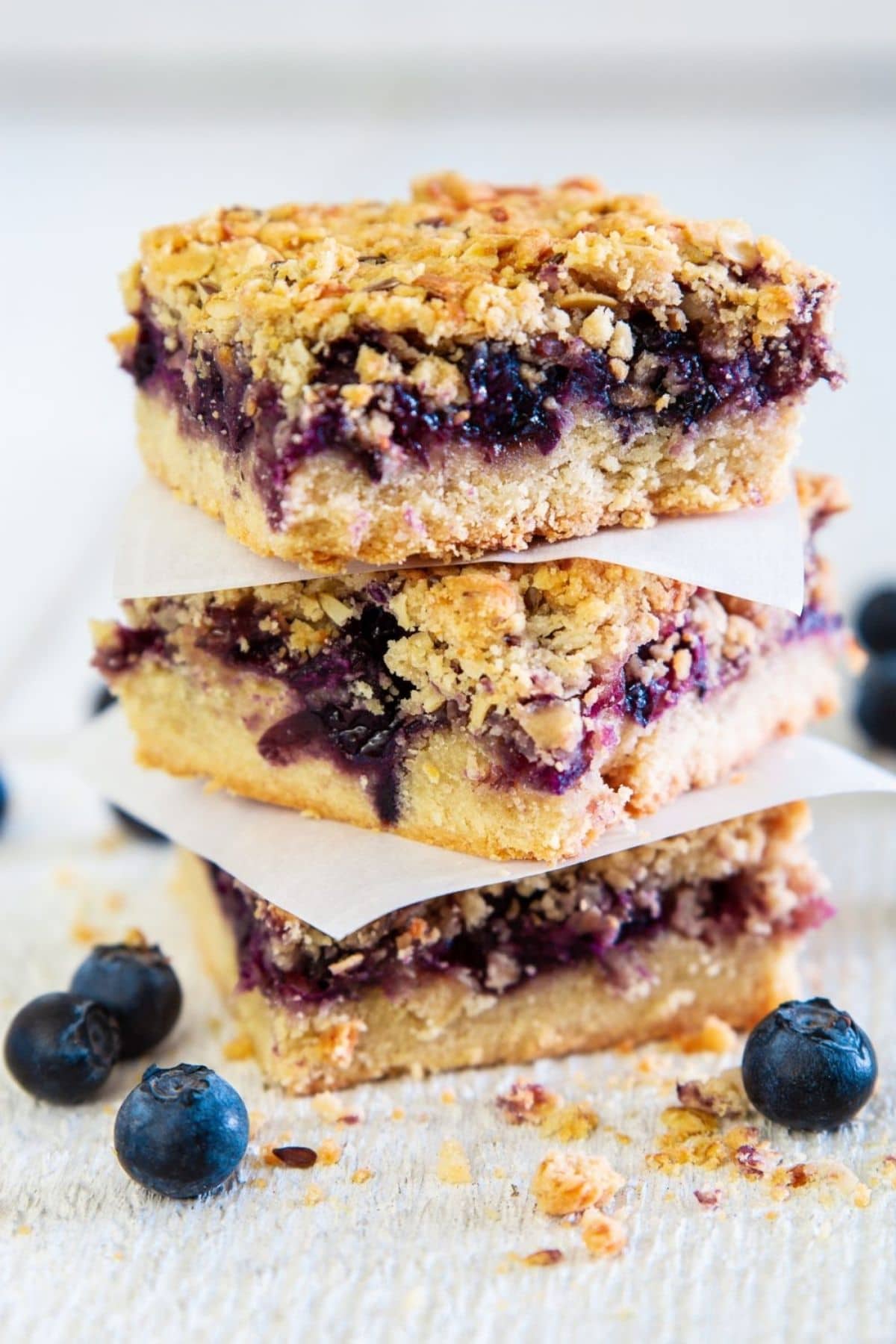 Blueberry crumb bars with waxed paper between slices