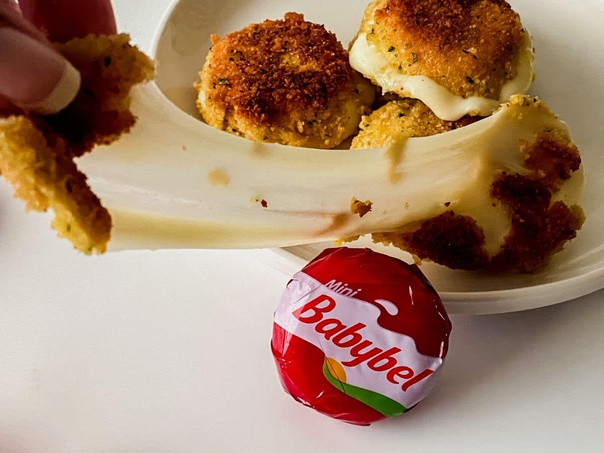 Plate of fried cheese with babybel round sitting in front