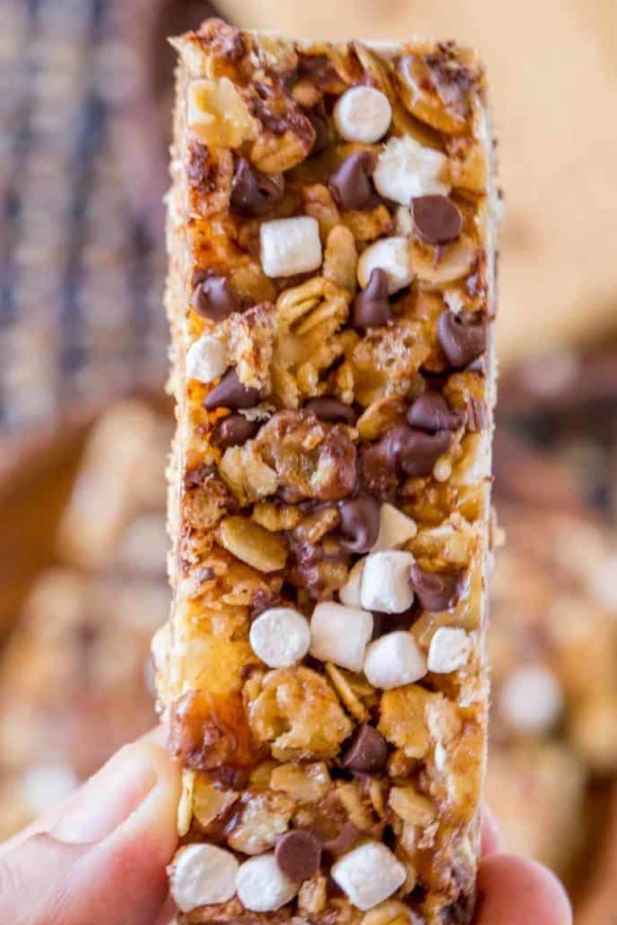 Hand holding granola bar with chocolate chips and mini marshmallows