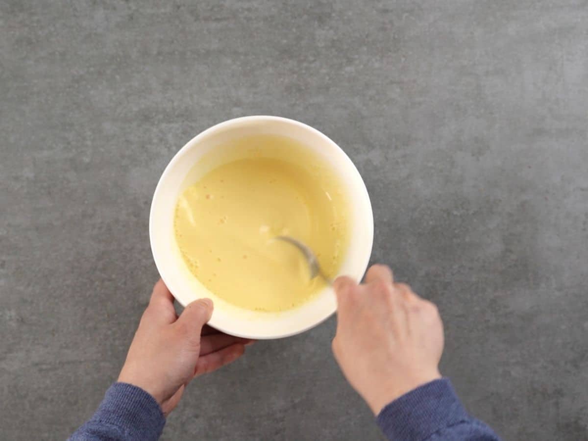 Stirring pudding in white bowl