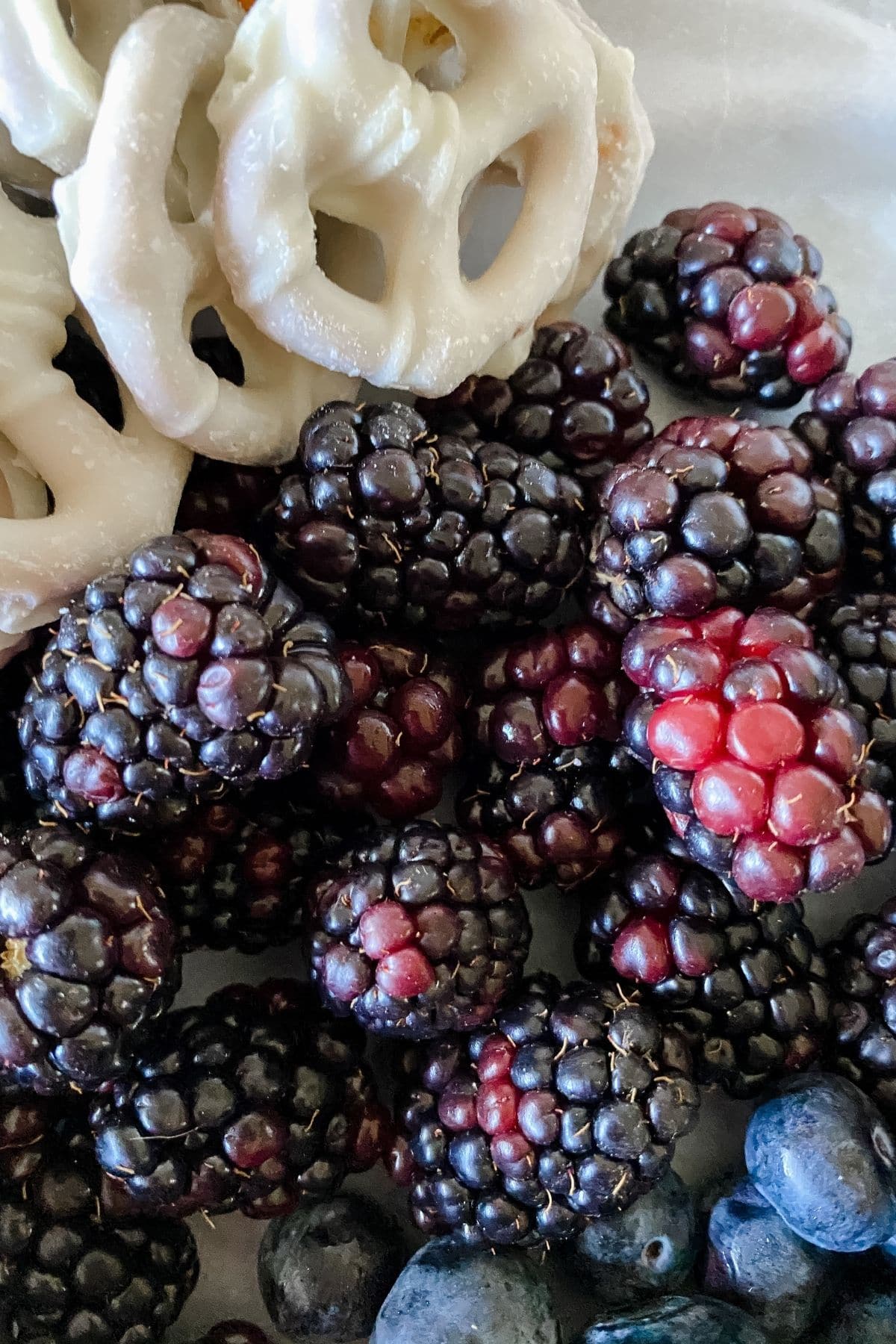 Blackberries next to white pretzels