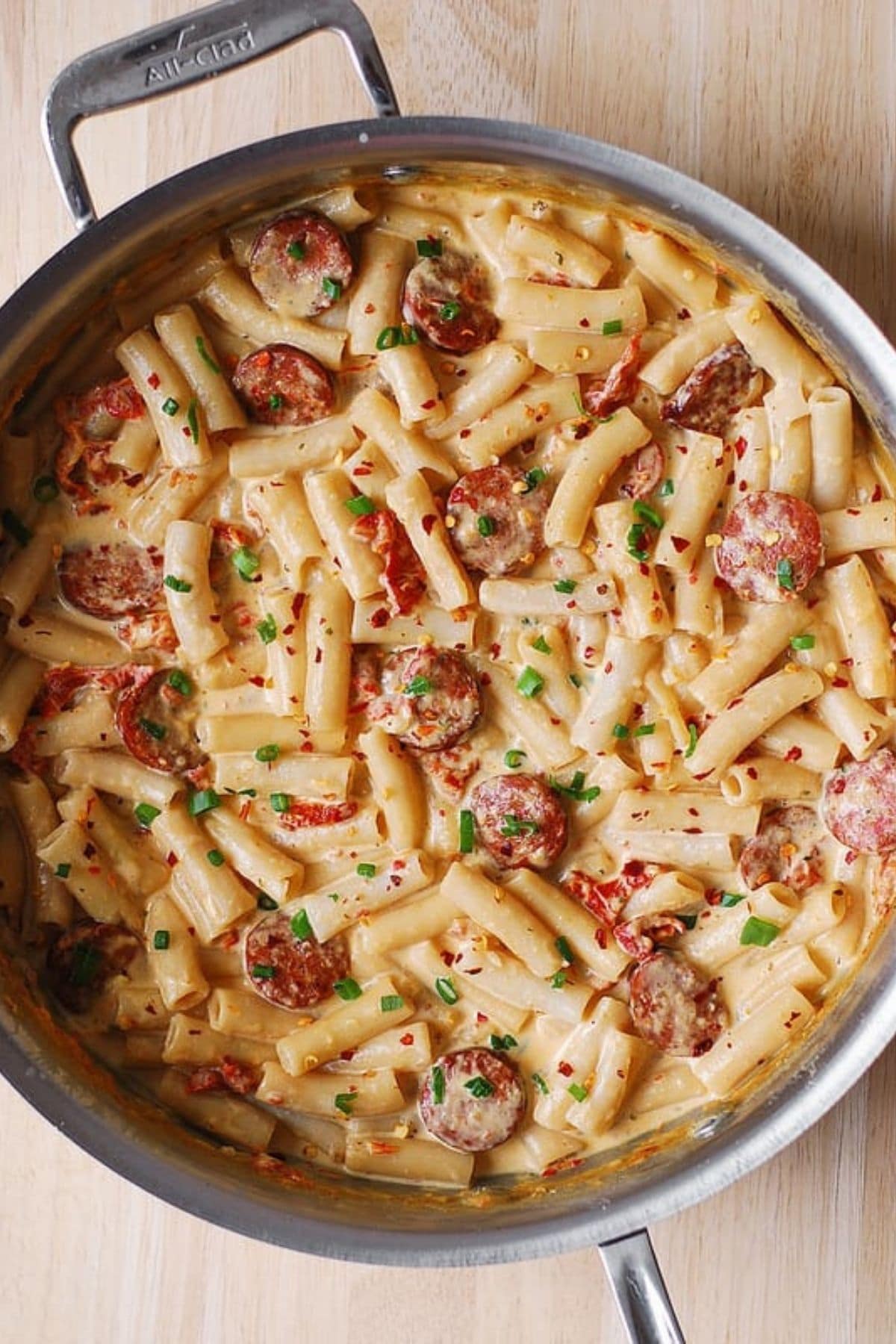 Spiral pasta in large skillet with creamy sauce