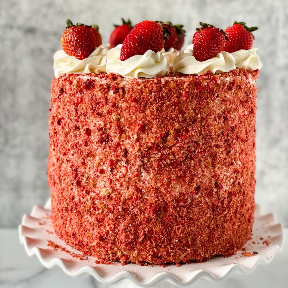 Cake with strawberries on top and gray background