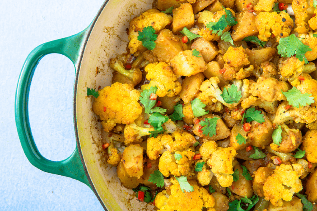 Aloo Gobi topped with cilantro and red chili