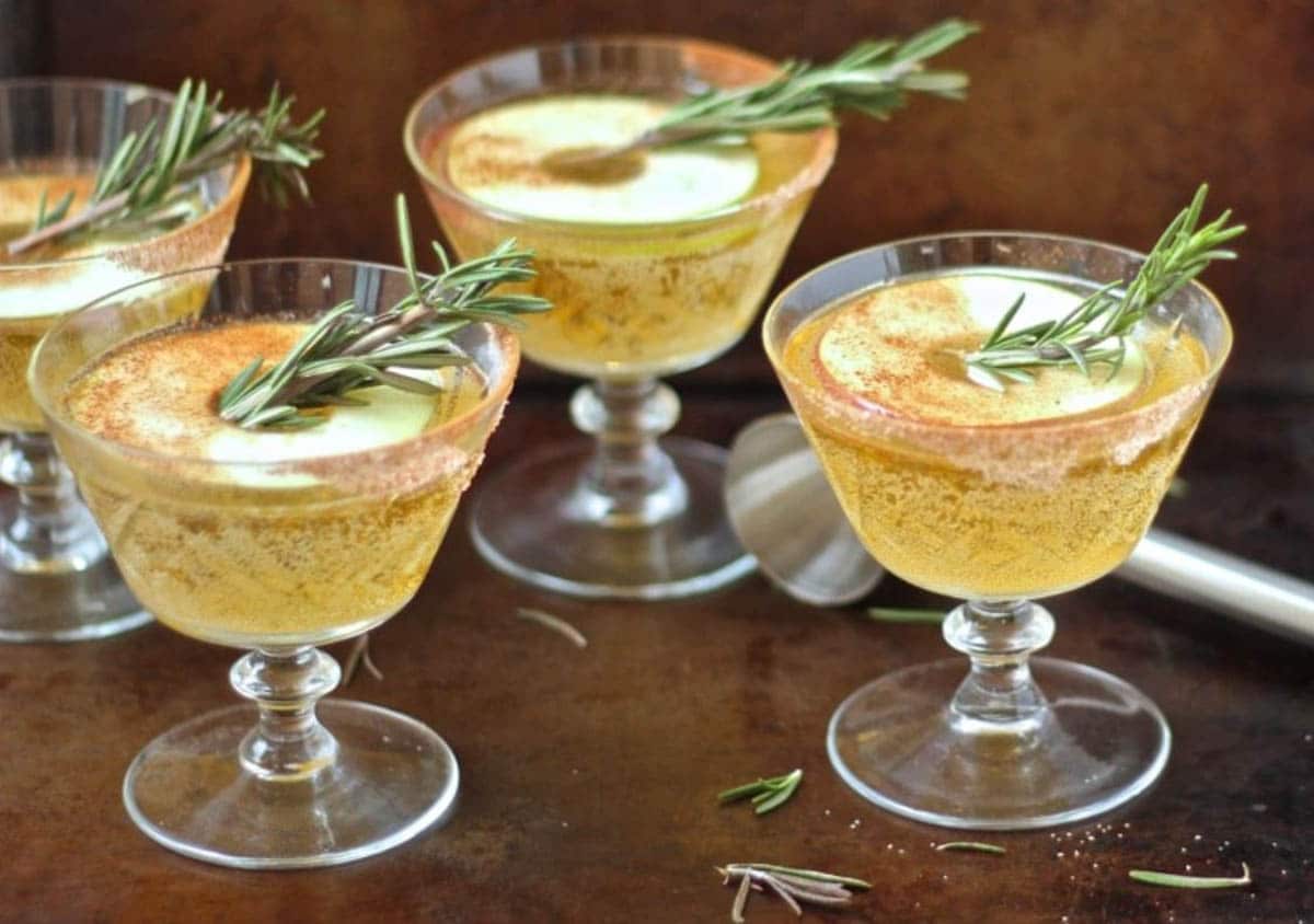 Autumnal Cinnamon Apple Whiskey Sour topped with rosemary