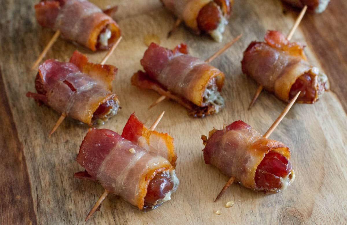 Bacon Wrapped Dates With Blue Cheese on a wood tray