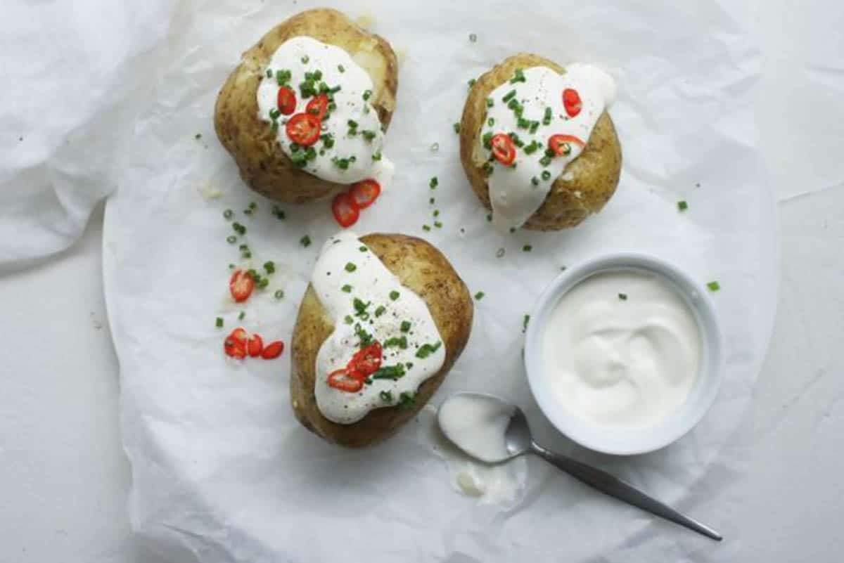 Baked Potatoes topped with sour cream chives and chili