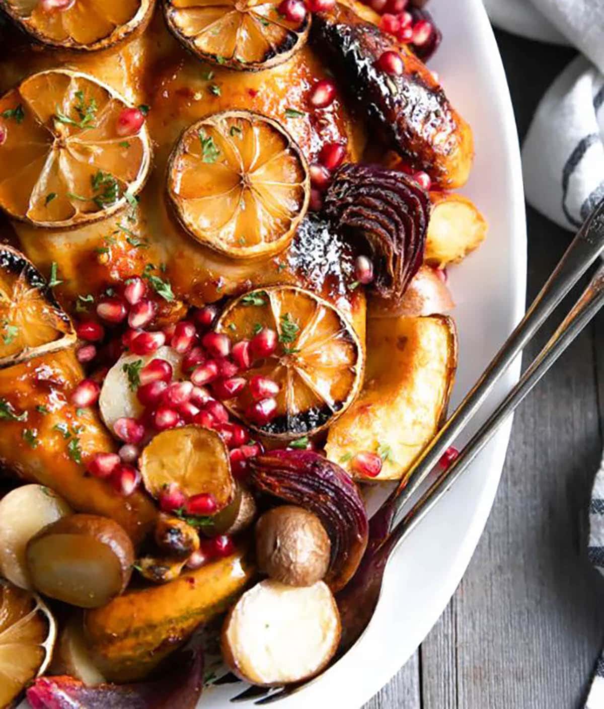 Bakes Harissa Chicken topped with orange slices and pomegranate seeds