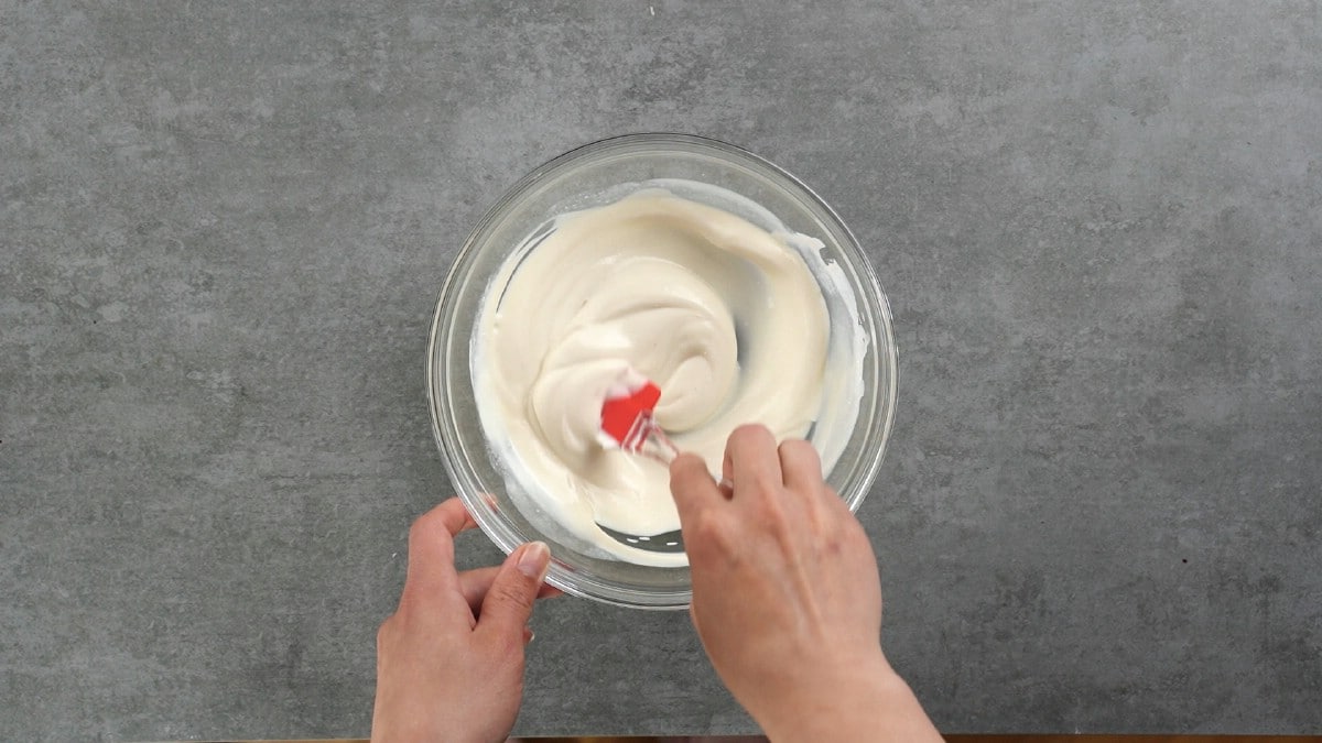 Mixing yogurt in glass bowl