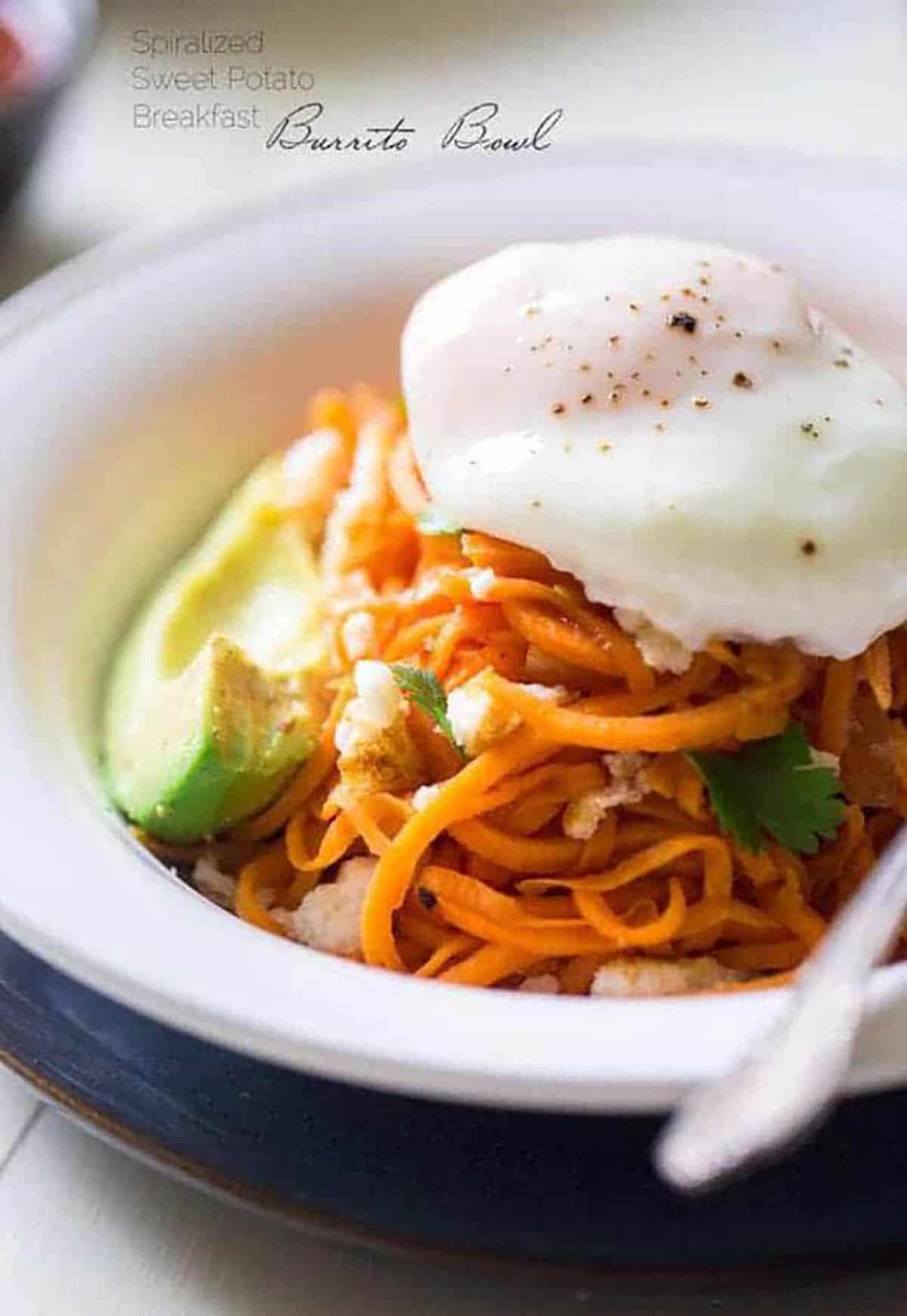 Breakfast Burrito Bowl with Sweet Potato Noodles topped with poached egg and sliced avocado
