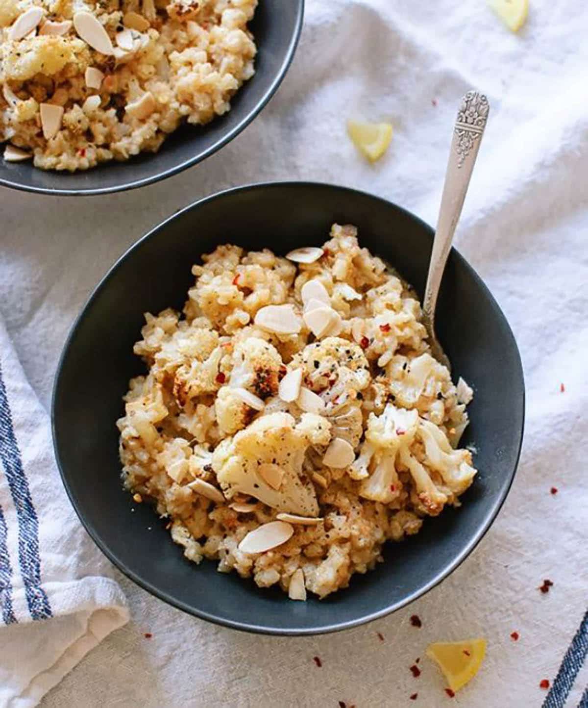 Cauliflower risotto topped with cauliflower and chopped almonds