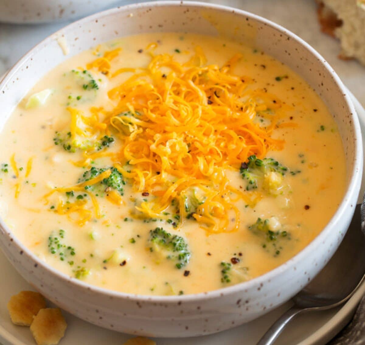 Cheese and Broccoli Soup topped with cheddar cheese in a bowl